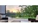 Relaxing patio area overlooking a pond, perfect for enjoying the sunrise and lush greenery at 7420 Wild Violet Dr, Cumming, GA 30040