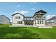 Spacious rear of home featuring covered patio and lake view at 7420 Wild Violet Dr, Cumming, GA 30040