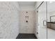 Sleek bathroom shower with a glass door, mosaic tile, and modern fixtures at 7420 Wild Violet Dr, Cumming, GA 30040
