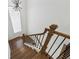Elegant staircase features a wood railing and black metal balusters, leading to the upper level at 7420 Wild Violet Dr, Cumming, GA 30040