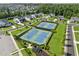 Aerial view of community tennis courts, showcasing the neighborhood's recreational amenities and landscaped surroundings at 7420 Wild Violet Dr, Cumming, GA 30040