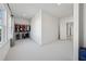 Bright walk-in closet with carpet, closet organization system, and view of the window and natural light at 7420 Wild Violet Dr, Cumming, GA 30040