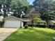 Charming single-story home with a well-manicured front lawn and mature trees at 10630 Worthington Hills Mnr, Roswell, GA 30076