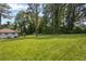 Green backyard with mature trees providing shade and privacy at 1769 W Austin Rd, Decatur, GA 30032