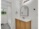 Bathroom featuring a modern vanity, arched mirror, and tub with subway tile at 1769 W Austin Rd, Decatur, GA 30032