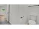 Cozy water closet featuring a modern toilet, dark fixtures and gray tile flooring at 1769 W Austin Rd, Decatur, GA 30032