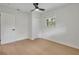 Bedroom features light wood floors, a ceiling fan, closet and bright windows at 1769 W Austin Rd, Decatur, GA 30032