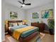 Bright bedroom with a wooden bed frame, ceiling fan, and natural light coming through the windows at 1769 W Austin Rd, Decatur, GA 30032