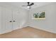 Bedroom features light wood floors, a ceiling fan, and bright windows at 1769 W Austin Rd, Decatur, GA 30032