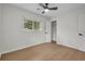 Bright bedroom featuring light wood floors, ceiling fan, and closet at 1769 W Austin Rd, Decatur, GA 30032