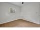 Bedroom features light wood floors, a ceiling fan, and bright windows at 1769 W Austin Rd, Decatur, GA 30032