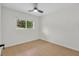 Bedroom features light wood floors, a ceiling fan, and bright windows at 1769 W Austin Rd, Decatur, GA 30032