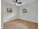 Bright bedroom featuring light wood floors, ceiling fan, and bright windows at 1769 W Austin Rd, Decatur, GA 30032