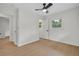 Well-lit bedroom features light wood floors, ceiling fan, and multiple windows at 1769 W Austin Rd, Decatur, GA 30032