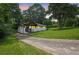 Serene view of the home and driveway nestled on a lush, tree-filled lot at dusk at 1769 W Austin Rd, Decatur, GA 30032