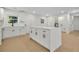 Modern kitchen with white cabinetry, a quartz island, and luxury plank floors offering both style and functionality at 1769 W Austin Rd, Decatur, GA 30032