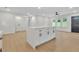 Spacious kitchen with new hardwood floors, white cabinetry, and a center island at 1769 W Austin Rd, Decatur, GA 30032