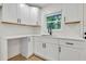 Close up of a renovated kitchen featuring sleek countertops, stainless sink, and modern cabinets at 1769 W Austin Rd, Decatur, GA 30032