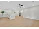 Bright, open kitchen with white cabinetry, large island, and modern ceiling fan at 1769 W Austin Rd, Decatur, GA 30032