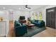 Bright living room boasts hardwood floors, a ceiling fan, and a large window overlooking the front yard at 1769 W Austin Rd, Decatur, GA 30032