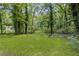 A tranquil yard offers privacy with mature trees and lawn at 2128 Kimberly Rd, Atlanta, GA 30331