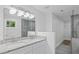 Modern bathroom with double vanity, granite countertops, large mirror and stylish lighting at 2128 Kimberly Rd, Atlanta, GA 30331