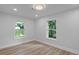Sun-filled bedroom features wood flooring, neutral paint, and large windows overlooking a yard at 2128 Kimberly Rd, Atlanta, GA 30331