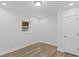 A bright bedroom with a window, door and wood-look flooring at 2128 Kimberly Rd, Atlanta, GA 30331