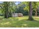 Quaint renovated home situated on a green lawn, surrounded by mature trees at 2128 Kimberly Rd, Atlanta, GA 30331