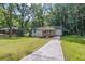 Newly renovated bungalow boasting a large grassy front yard with mature shade trees at 2128 Kimberly Rd, Atlanta, GA 30331
