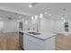 Bright kitchen boasts granite counters, stainless steel appliances, and an island with pendant lighting at 2128 Kimberly Rd, Atlanta, GA 30331