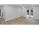 Open-concept living room with neutral paint, wood flooring, and French doors to the deck at 2128 Kimberly Rd, Atlanta, GA 30331