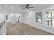 Bright living room with large windows, open to kitchen and light-colored, hard-surface flooring at 2128 Kimberly Rd, Atlanta, GA 30331