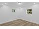 Bright room featuring hardwood floors and two windows at 2128 Kimberly Rd, Atlanta, GA 30331