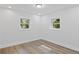 Bright room featuring hardwood floors and two windows at 2128 Kimberly Rd, Atlanta, GA 30331
