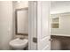 Half bathroom featuring a modern vanity with a framed mirror and updated fixtures at 2629 Irwell Way, Lawrenceville, GA 30044