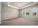 Sunlit bedroom with plush carpeting and large windows offering neighborhood views at 2629 Irwell Way, Lawrenceville, GA 30044