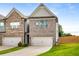 Townhome with a two-car garage, attractive landscaping, and private driveway at 2629 Irwell Way, Lawrenceville, GA 30044