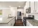 Modern kitchen featuring granite counters, a subway tile backsplash, and stainless steel appliances at 2629 Irwell Way, Lawrenceville, GA 30044