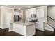 Bright kitchen featuring a granite island, stainless steel appliances, and dark hardwood floors at 2629 Irwell Way, Lawrenceville, GA 30044