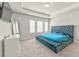Main bedroom featuring a tufted platform bed, tray ceiling, and natural light at 2629 Irwell Way, Lawrenceville, GA 30044