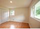 Bedroom boasts hardwood floors, a spacious closet, and natural lighting at 5254 Corinth Dr, Stone Mountain, GA 30087