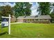 Charming one story home with a well-manicured lawn and mature trees at 5254 Corinth Dr, Stone Mountain, GA 30087