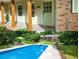 Inviting front porch with rustic wood columns and charming green door at 5254 Corinth Dr, Stone Mountain, GA 30087
