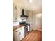Modern kitchen featuring stainless steel appliances, wood counters, and white cabinets at 5254 Corinth Dr, Stone Mountain, GA 30087