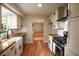 Bright kitchen features modern appliances, wooden counters, white cabinets, and a farmhouse sink at 5254 Corinth Dr, Stone Mountain, GA 30087