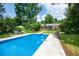 Refreshing backyard pool with lounge area and lush greenery at 5254 Corinth Dr, Stone Mountain, GA 30087