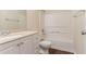 Bright bathroom with a vanity, mirror, and combination tub and shower at 6528 Carriage Ln, Stone Mountain, GA 30087