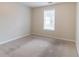 Neutral carpeted bedroom with a window allowing natural light at 6528 Carriage Ln, Stone Mountain, GA 30087