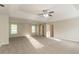 Spacious bedroom with two windows, carpet flooring and ceiling fan at 6528 Carriage Ln, Stone Mountain, GA 30087